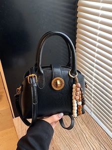 Classic black semi-circular shell bag with gold twist lock and bohemian wooden beads