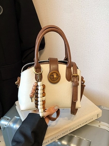 Chic cream white shell-shaped handbag with brown leather straps and vintage bead charm
