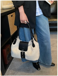 Detail of plush winter tote bag showing soft faux fur texture and black leather strap
