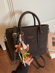 Vintage dark brown suede bucket tote bag with cute plush bear charm and crossbody strap