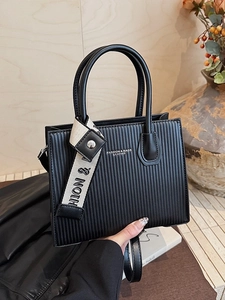 Fashion black striped handbag with dual handles and logo straps for daily commuting