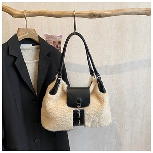 Detailed view of winter tote bag with cream faux fur texture and black leather straps