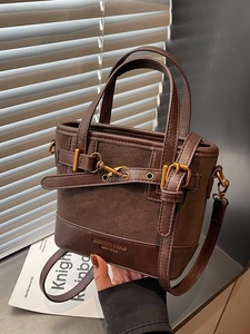 Retro dark brown bucket bag with matte texture, gold metal buckle and top handles