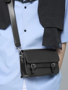 Chic black crossbody square bag with dual silver buckles and adjustable leather strap