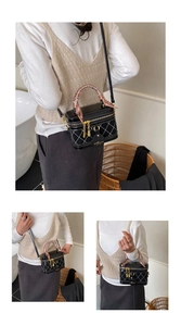 Detail of black quilted vanity bag with pink silk scarf handle and golden hardware