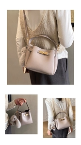 Detail of grey-purple lychee pattern leather bucket bag with gold lock and rabbit charm