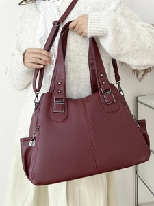 Deep wine red large capacity tote bag with lychee texture shown on model shoulder
