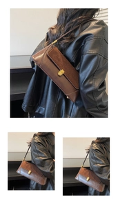 Detail of vintage brown baguette bag showing suede and leather texture with gold clasp