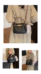 Close-up of pebble leather bucket bag with contrast trim and cute rabbit charm detail