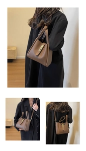 Detail of brown lychee grain leather bucket bag featuring elegant gold twist lock and strap
