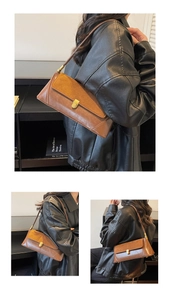 Brown faux leather baguette bag worn over the shoulder featuring gold lock detail