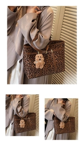 Detail of leopard print tote bag with brown handles and a cute plush bear charm