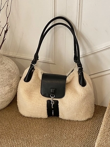 Faux fur shoulder bag in creamy white with black leather straps and metal buckle