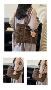 Detail of leopard print tote bag with plush bear charm and brown adjustable shoulder strap
