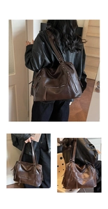Detail of vintage brown leather tote bag showing multiple functional zipper pockets and rivets