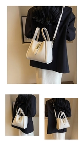 Close-up of creamy white lychee grain leather bucket bag with metal buckle and strap