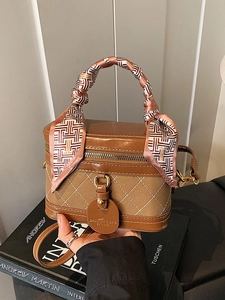 Vintage brown quilted box bag with a silk scarf handle and adjustable shoulder strap