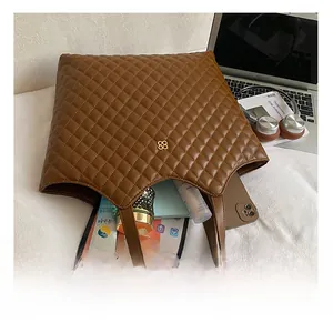 Interior view showing the large capacity of the brown quilted tote bag for women