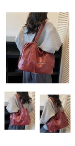 Close-up of red vintage PU leather tote bag with functional zippers and metal rivets