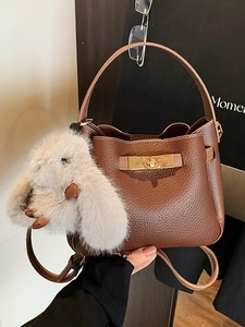Retro dark brown pebbled leather bucket bag with golden lock and plush rabbit charm