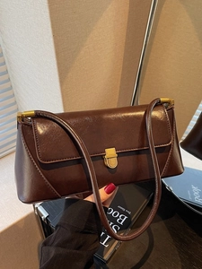 Classic dark brown leather baguette bag with gold buckle for women in winter style