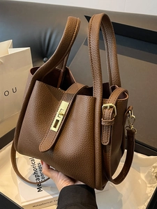 Dark brown lychee grain leather bucket bag with gold buckle and adjustable strap