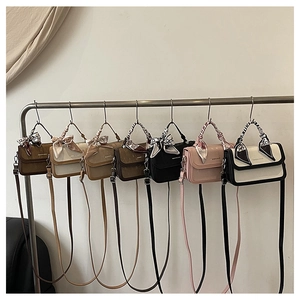 Multiple colors of stylish flap crossbody bags with silk scarf details on handles