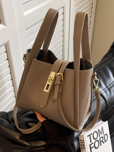 Litchi pattern leather bucket bag in dark brown with gold turn-lock and shoulder strap