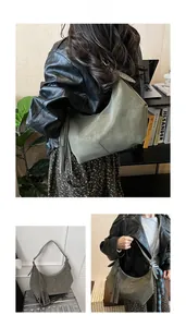 Detail of olive green suede shoulder bag featuring bohemian tassels and metal rivets