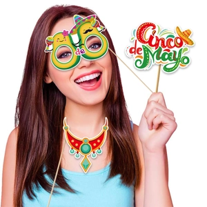 Close-up of Cinco de Mayo photo props featuring avocado glasses and colorful festival signs