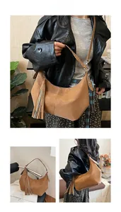 Brown hobo shoulder bag with bohemian tassel and studded strap detail views