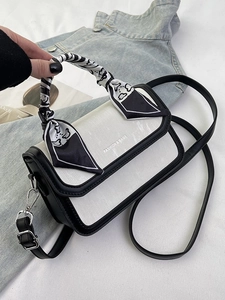 Chic cream-colored small square handbag with scarf handle and black crossbody strap