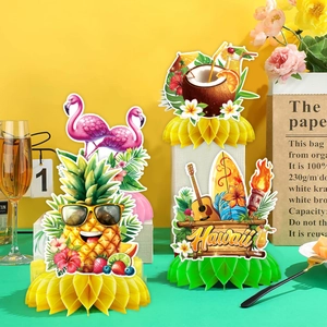 Hawaii party honeycomb centerpieces featuring pineapple and flamingo paper decorations