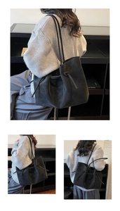 Detail view of black matte bucket bag featuring side knot design and drawstring closure