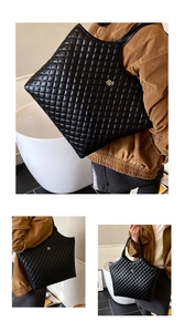 Detail showing black quilted tote bag with golden clover charm and stitched diamond patterns