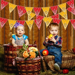 Western cowboy bandana party banners with red and yellow paisley patterns on wood wall