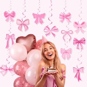 Pink bow birthday party decorations with spiral swirls and glitter cardstock cutouts