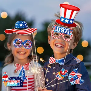 Kids celebrating 4th of July with festive USA themed paper props and party accessories