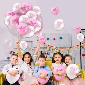 Pink and white bow-themed party balloons shown with children in a festive birthday setting