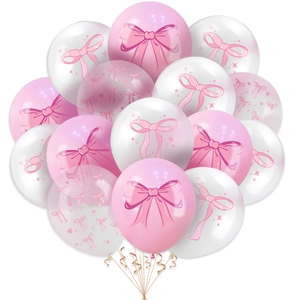 Close-up of pink and white latex balloons with bow prints and golden spiral ribbons