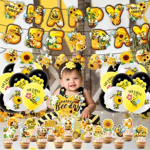 Close-up of Bee themed birthday party set with banners, balloons, and cake toppers