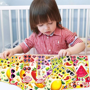 Close-up of a child playing with DIY fruit stickers featuring lemon and strawberry themes