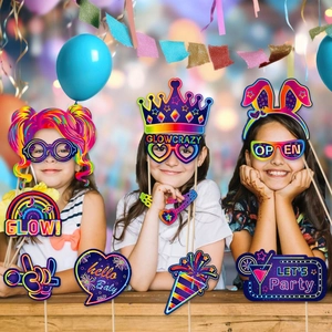 Macro detail of neon glow birthday party photo booth props with vibrant fluorescent colors