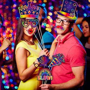 Neon glow party photo booth props set with colorful crowns and glow signs for birthdays