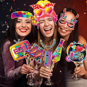 Three cheerful women posing with retro 80s party photo booth props and neon accessories