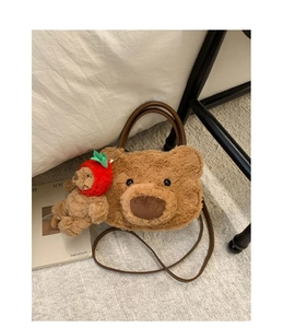 Detail of plush bear shoulder bag with soft texture and strawberry bear keychain accessory