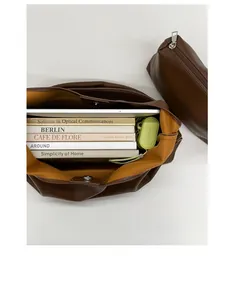 Interior view of brown leather tote showing bright yellow lining and large capacity