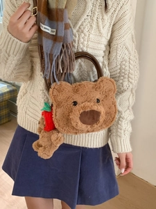 Cute brown plush bear-shaped handbag with matching charm and leather handle