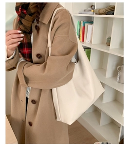 Side view of a minimalist large off-white tote bag with lychee grain leather texture