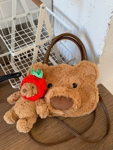 Cute brown plush teddy bear handbag with strawberry bear charm and leather handles
